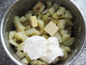 Hot potatoes with moisture steamed off ready to mash