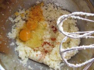 Add eggs, oil, vanilla, lemon zest