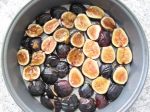 Sliced figs and honey on parchment paper