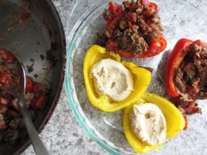 Add hummus to peppers then top with lamb