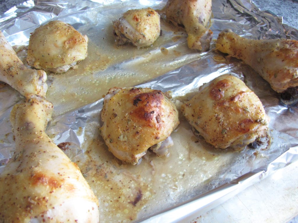 Roasted chicken pieces on the pan