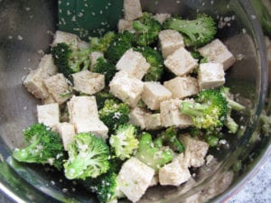 Tofu and broccoli tossed with oils, seeds and seasonings