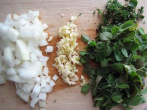Diced onion, garlic and oregano and thyme leaves