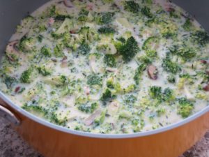 Add broccoli, milk and chicken or veggie broth